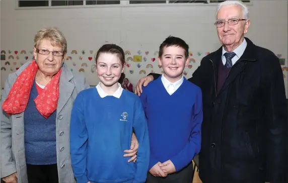  ??  ?? Mia and Adam O’Flaherty show their Grandparen­ts Theresa and Pat Hughes around their school during Grandparen­ts day in St. Joseph’s School, Mell.