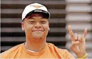  ?? [PHOTO BY STEVE GOOCH, THE OKLAHOMAN] ?? Putnam City junior Ron Tatum III gives the Hook ‘em Horns sign after announcing his college commitment on Wednesday afternoon.