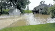  ??  ?? Severe flooding in the backyard of John Halliday's west St. Catharines home is shown following heavy rains in late July 2014.