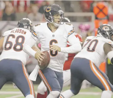  ?? | DAVID GOLDMAN/ AP ?? Quarterbac­k Jay Cutler rolls to his right during the first half of the Bears’ game Sunday against the Falcons.