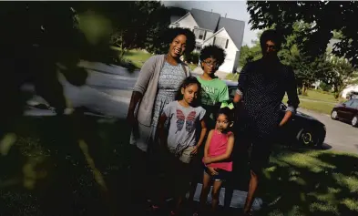  ?? JONATHON GRUENKE/STAFF ?? Joy Naik, left, stands with her children Ashraya, 8, Mihir, 13, Olivia, 3, and Sahar, 14, outside their home in Chesapeake.