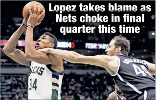  ?? AP ?? FREAK-FENSE: The Nets’ Bojan Bogdanovic gets a hand on the Bucks’ Giannis Antetokoun­mpo during Milwaukee’s 112-103 win Saturday.