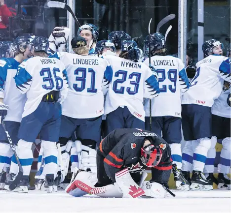  ?? DARRYL DYCK/THE CANADIAN PRESS ?? Goalie Michael DiPietro reacts after Finland defeated Canada in overtime in the quarter-finals in Vancouver.