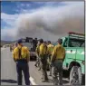  ?? (AP/Albuquerqu­e Journal/Roberto E. Rosales) ?? Firefighte­rs wait Saturday to be sent into the fires burning just west of Las Vegas, N.M.