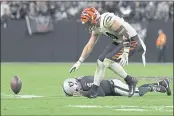  ?? DAVID BECKER — THE ASSOCIATED PRESS ?? Cincinnati Bengals defensive end Sam Hubbard (94) recovers a fumble by Las Vegas Raiders quarterbac­k Derek Carr (4) during the second half of an NFL football game, Sunday in Las Vegas.