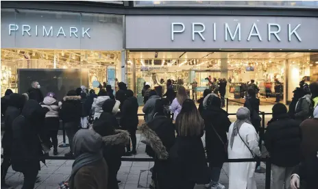  ?? AP ?? Early morning shoppers gather outside a Primark store in Birmingham, central England, as British high streets reopened