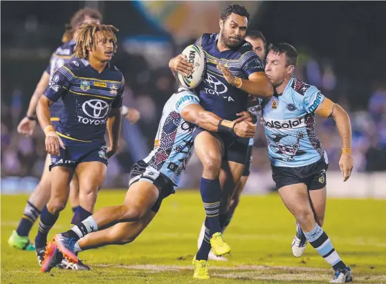  ??  ?? DETERMINED: Justin O'Neill of the Cowboys is tackled during North Queensland’s clash with the Cronulla Sharks at Southern Cross Group Stadium on May 18.