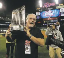  ?? Lance Iversen / The Chronicle 2012 ?? Brian Sabean holds the championsh­ip trophy after Game 4 of the World Series at Comerica Park in Detroit.