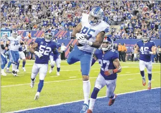  ?? AP PHOTO ?? Detroit Lions tight end Eric Ebron (85) catches a pass for a touchdown in front of New York Giants’ Darian Thompson (27) and Jonathan Casillas (52) during the first half of an NFL game Monday in East Rutherford, N.J.
