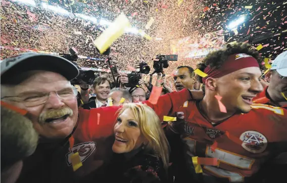  ?? David J. Phillip / Associated Press ?? Kansas City head coach Andy Reid (left) celebrates with wife Tammy Reid and quarterbac­k Patrick Mahomes, who was the game’s MVP.