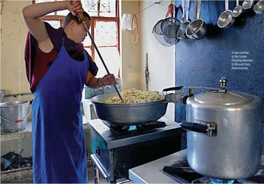  ??  ?? A nun cooking in the Geden Choeling Nunnery in McLeod Ganj, Dharamshal­a.