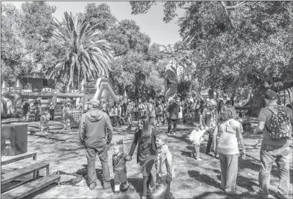  ?? Signal file photo ?? (Above) Hundreds gather at the Purim Carnival hosted by Temple Beth Ami during a previous Purim festival, held at Hart Park in Newhall. (Below) Inflatable sumo wrestling was among the games and activities at a previous carnival.