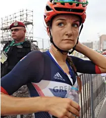  ??  ?? Left: Anna van Vleuten loses control on the terrifying descent yesterday and flies over the handlebars. She ended up unconsciou­s in the gutter. Right: Doping row Briton Lizzie Armitstead recovers after coming fifth