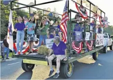  ?? COURTESY PHOTO ?? Rappahanno­ck resident and Democratic congressio­nal candidate Leslie Cockburn (second from left in turquoise shirt) chose to ride on a hay wagon for the parade.