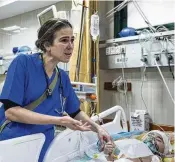  ?? ABDEL KAREEM HANA / AP ?? A pediatrici­an examines a wounded Gazan child at AlAqsa Martyrs Hospital in central Gaza. Israel is carrying out raids in and around two hospitals.