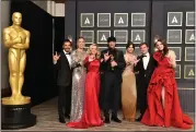  ?? PHOTO BY JORDAN STRAUSS/INVISION/AP ?? Eugenio Derbez, from left, Sian Heder, Marlee Matlin, Troy Kotsur, Emilia Jones, Daniel Durant and Amy Forsyth, from the best picture award winner “CODA,” pose in the press room while signing “I love you” at the Oscars on Sunday.