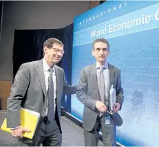  ?? STEPHEN JAFFE/GETTY IMAGES ?? Internatio­nal Monetary Fund economic counsellor and director of the research department Maurice Obstfeld, left, and deputy director Gian Maria Milesi-Ferretti walk off the stage after a press conference on Tuesday. The IMF says Canadian economic data points to growth in GDP.