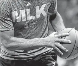  ?? Streeter Lecka / Getty Images ?? NBA players have been warming up in shirts to pay tribute to Dr. Martin Luther King Jr. in the recent days leading up to Monday’s traditiona­l MLK schedule.