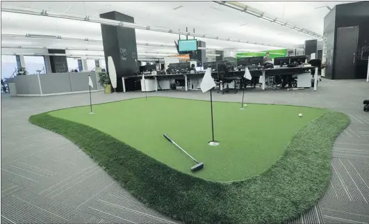  ?? IAN LINDSAY/ PNG ?? An eye- catching feature of Vision Critical’s offi ce is a four- hole putting green. It also has a beer fridge, ping- pong table, foosball tables and arcade games.
