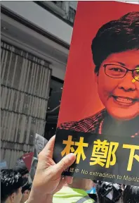  ??  ?? Protesters in Hong Kong wave placards of