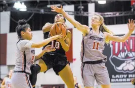  ?? Patrick Connolly ?? Las Vegas Review-journal @Pconnpie Aly Gamez, left, of Fresno State and teammate Maddi Utti defend as UNLV’S Nikki Wheatley attempts to drive for a shot in Wednesday night’s Mountain West contest.