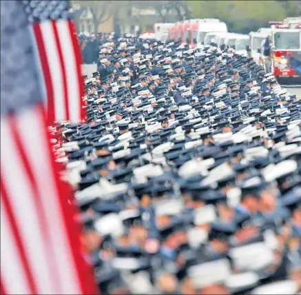  ??  ?? OUTPOURING OF RESPECT: Thousands of Bravest line the funeral procession Thursday in Bethpage, LI, for FDNY firefighte­r William Tolley, whose widow, Marie, and 8-year-old daughter, Bella (right), received vows of support from his comrades during an...