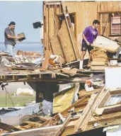  ?? SEAN RAYFORD / GETTY IMAGES ?? Joe Woll, left, and son Wesley look through their house
in Grand Isle, La., Friday, in the wake of Hurricane Ida.
