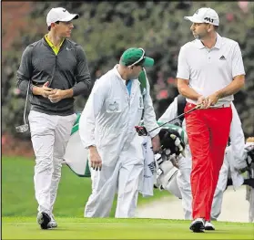  ??  ?? Rory McIlroy and Sergio Garcia chat during their practice round on Wednesday morning.“I think it’s been a relatively quiet buildup to the Masters for me, which has been quite nice,” McIlroy said.