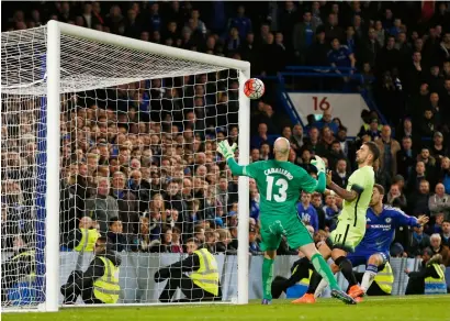  ?? Reuters ?? Bertrand Traore (not pictured) scores the fifth goal for Chelsea as Man City’s Willy Caballero looks on during an FA Cup match. —