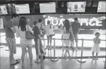  ?? Greg Baker Associated Press ?? U.S. FILMMAKERS are limited to 34 releases a year in China. Above, the ticket line at a Beijing theater.