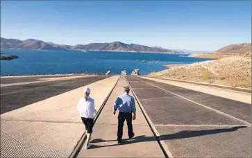  ?? Photograph­s by Allen J. Schaben
Los Angeles Times ?? METROPOLIT­AN Water District managers Sheri Shaffer and Armando Acuna inspect Diamond Valley Lake. In a mega- drought simulation, urban water rates would climb and lawns would all but disappear.