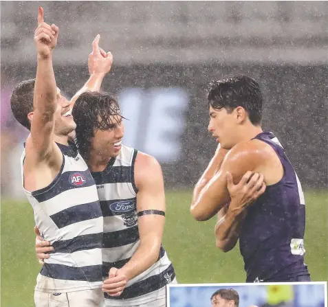  ?? Pictures: GETTY ?? Sam Menegola and Jack Henry celebrate a goal; and (right) Tom Hawkins gets a handball away in slippery conditions.