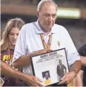  ??  ?? Former Arizona State football coach Darryl Rogers accepts his plaque as he is inducted into the ASU Hall of Fame in 2012.