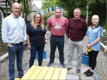  ??  ?? Staff at the Red Door project in the garden that has been created by the service users.