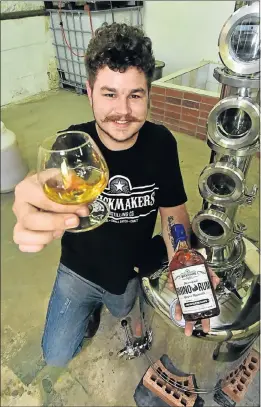  ?? Picture: EUGENE COETZEE ?? CHARGING ONTO MARKET: Eugene Coertzen with the Rhino Rum he distills at his Baakens Valley company