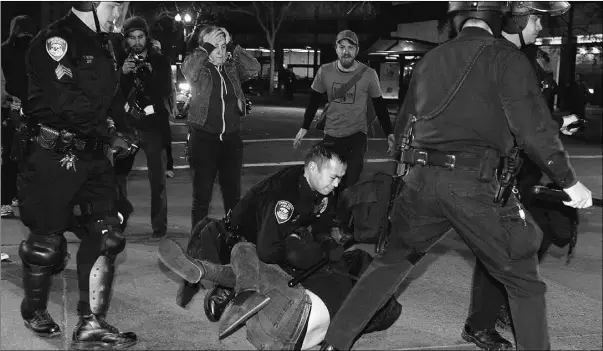  ?? Stephen Lam, Reuters ?? A demonstrat­or is arrested during a daylong protest in Oakland on Saturday that saw ‘Occupy’ protesters try to take over a vacant convention centre.