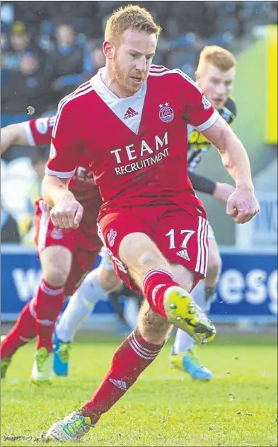  ??  ?? n Aberdeen striker Adam Rooney wins the game for the away side with a precise strike from the spot.