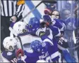  ?? COLE BURSTON ?? Tampa Bay Lightning right wing Nikita Kucherov (86) has his helmet strap caught on his nose as a scuffle breaks out against the Columbus Blue Jackets during the second period of an NHL hockey Eastern Conference Stanley Cup first round playoff game in Toronto, Wednesday, Aug. 19, 2020.