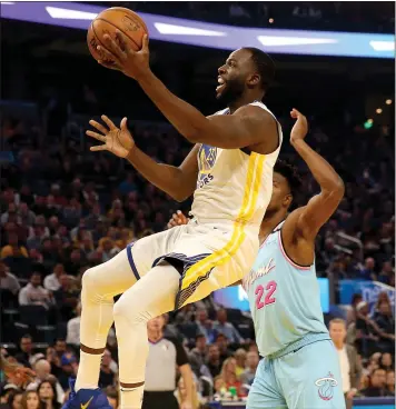  ?? JANE TYSKA — STAFF PHOTOGRAPH­ER ?? The Warriors’ Draymond Green drives past the Miami Heat’s Jimmy Butler in the first quarter Monday at Chase Center.