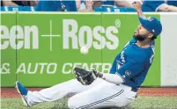  ?? FRED THORNHILL/THE CANADIAN PRESS ?? Blue Jays third baseman Richard Urena makes a sliding catch.
