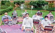  ?? —PTI ?? Eight suspended RS MPs display placards as they protest over their suspension in New Delhi on Monday.