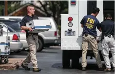  ?? Yi-Chin Lee / Houston Chronicle ?? FBI agents collect evidence from the Dannenbaum Engineerin­g firm on West Alabama Street in Houston on Wednesday. The FBI also raided the company’s locations in San Antonio, McAllen and Laredo.