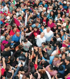 ?? Photo: Reuters ?? Andres Manuel Lopez Obrador is mobbed by supporters during the march in Mexico City.