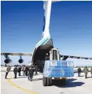  ?? ?? HELP. Workers unload aid from the United Arab Emirates at an airport in Latakia.