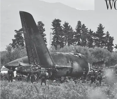  ?? RYAD KRAMDI / AFP / GETTY IMAGES ?? Rescuers work around the wreckage of an Algerian army plane that crashed after taking off near the Boufarik airbase on Wednesday. Officials say 257 people were killed, mostly army personnel and members of their families.