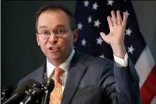  ??  ?? Mick Mulvaney holds up his hand as he speaks during a news conference after his first day as acting director of the Consumer Financial Protection Bureau in Washington on Monday. AP PHOTO