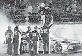  ?? LYNNE SLADKY AP ?? Noah Gragson celebrates on the roof of his car with his team after winning the NASCAR Xfinity Series Contender Boats 300 and a spot in the Championsh­ip 4.