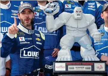  ?? AP PHOTO BY NICK WASS ?? In this June 4, 2017, file photo, Jimmie Johnson, left, poses with the trophy in Victory Lane after he won a NASCAR Cup series auto race at Dover Internatio­nal Speedway in Dover, Del. Jimmie Johnson has a track-record 11 wins at Dover Internatio­nal Speedway.