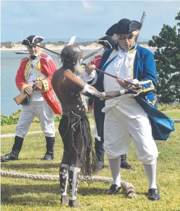  ??  ?? COLLABORAT­ION: The Cooktown Re-enactment Associatio­n marked the 250th anniversar­y of Captain Cook’s arrival on the shores of Waalmbal Birri, the Endeavour River, with a re-enactment including his first meeting with the Guugu Yimithirr people.