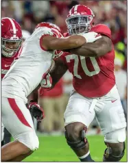  ?? (AP file photo) ?? Alabama offensive tackle Alex Leatherwoo­d (right) blocks Arkansas defensive end Mataio Soli last season. Leatherwoo­d won the Outland Trophy this season for the nation’s top interior lineman.